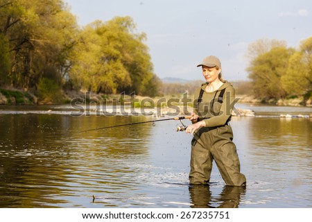 woman fishing in the river in spring