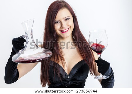 portrait of young woman with a glass of red wine and carafe