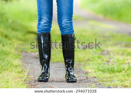 detail of standing woman wearing rubber boots