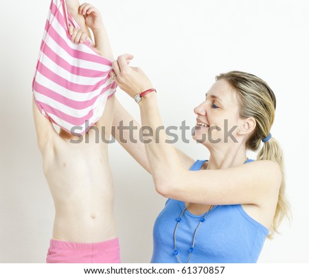 portrait of mother with her daughter during changing the clothes