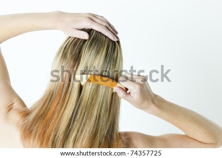 detail of woman combing long hair