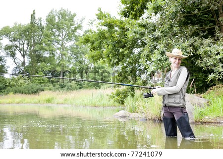 woman fishing in pond