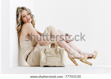 sitting woman wearing summer clothes and shoes with a handbag