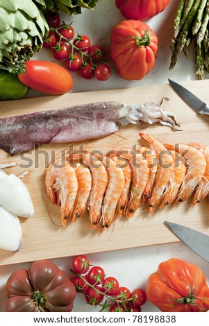 still life of raw seafood and vegetables