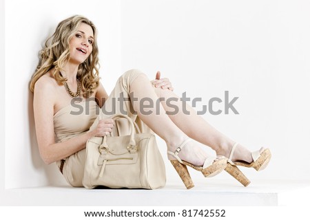 sitting woman wearing summer clothes and shoes with a handbag