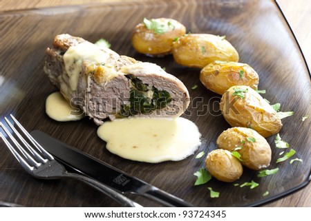 baked pork tenderloin filled with spinach and goat cheese on cream