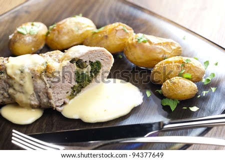 baked pork tenderloin filled with spinach and goat cheese on cream