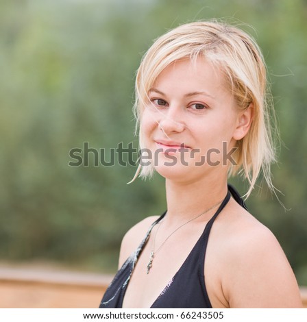 Portrait of young woman having rest on  nature