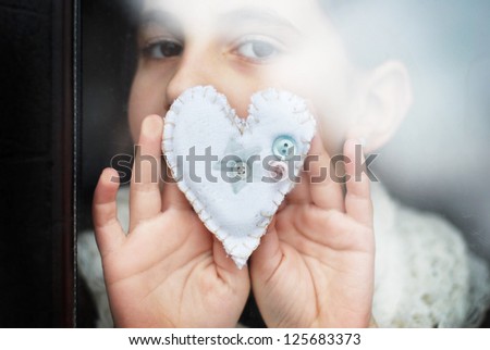 little girl gives a heart