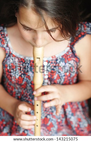 Little girl playing the flute