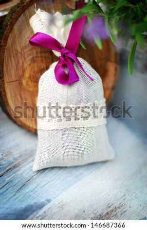 lavender bag and some fresh lavender flowers on at wooden box