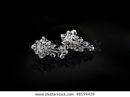stock photo Beautiful earrings from crystals on a black background