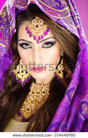 Portrait of a beautiful female model in traditional indian bridal costume and jewellery and makeup