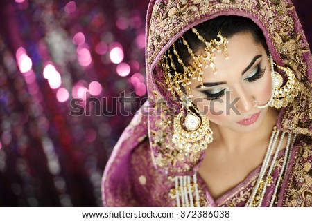 Portrait of a Beautiful Elegant Female Model in Traditional Ethnic Indian Asian Bridal  Costume with Makeup and Heavy Jewellery