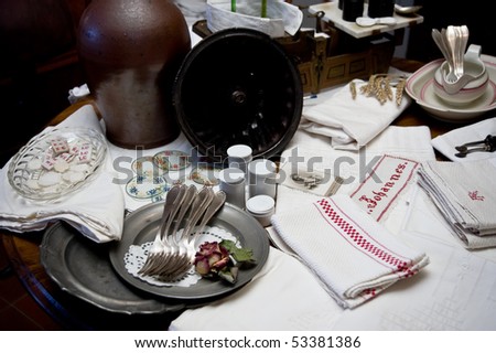 arrangement of old pottery and tableware inside and outside an antique shop