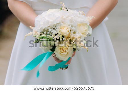 Beautiful summer wedding bouquet and wedding dress. Delicate bright flowers for girls