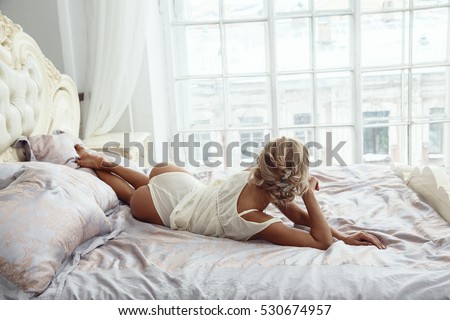 Beautiful sexy blonde girl posing in the morning in the hotel\'s interior