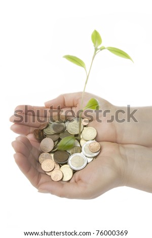 new plant sprouting from a hand with money - concept for business, innovation, growth and money. isolated on white