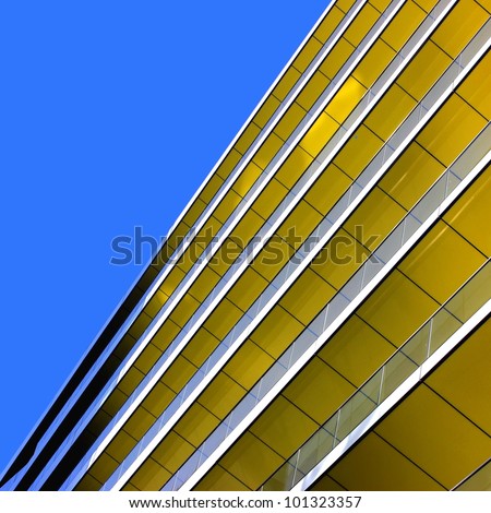 Complex building structural detail, yellow metal bars and glass