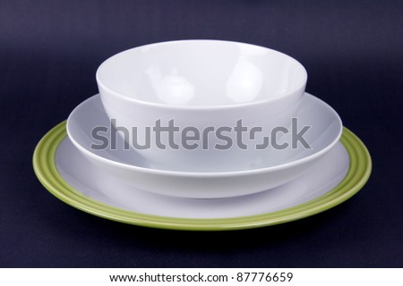 Set of crockery with bowl and plate on black background 	Set of crockery with bowl and plate on black background