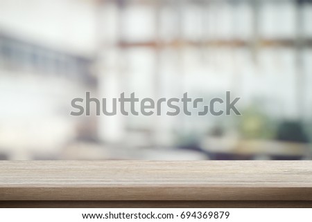 Wood table top on blur cafe interior background. Image can be used for montage your products. Mock-Up.