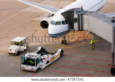 Airport. Airplane is being serviced by the ground crew.