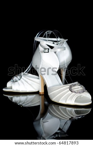 stock photo Elegant wedding shoes isolated on black background