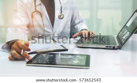 medicine doctor working with computer notebook at desk in the hospital