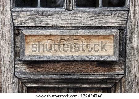 Carved OPEN sign on wooden door