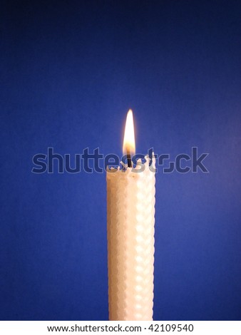 White Beeswax Candle With Dark Blue Background