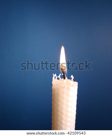 White Beeswax Candle With Blue Background