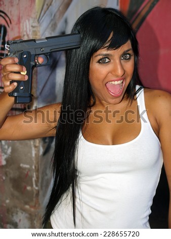 Mad woman with a gun pointing to her head