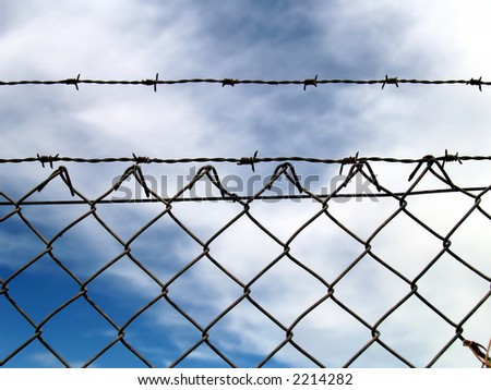 Metallic fence with barbed wire