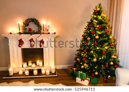 Wonderful new year details, beautiful furry tree with presents under it and a white fireplace full of candles. Xmas Home Interior Decoration, Hanging Sock and Present Toys.