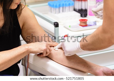 A swab is pressed onto the injection site during the blood collection