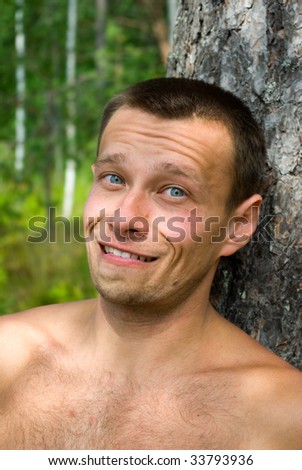 Portrait of smiling young adult man in forest