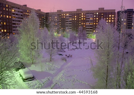 Evening snow-covered yard in residential district. Saint-petersburg. Russia