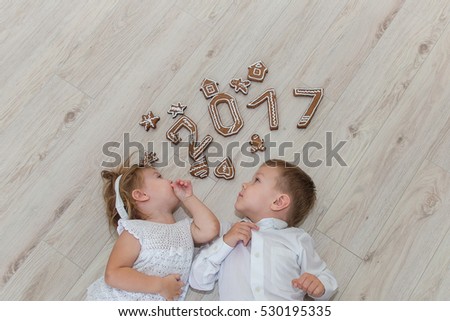 Children playing with gingerbread New Year\'s Eve.