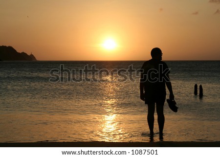 Man watching sunset *** Local Caption *** Man watching sunset. Colombia. Taganga Bay.