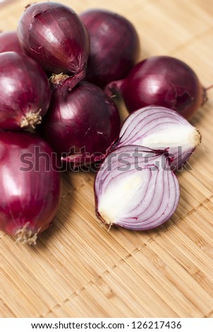 red  bulb onions on a bamboo background
