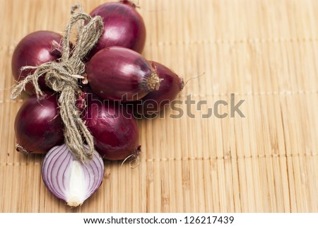 red  bulb onions on a bamboo background