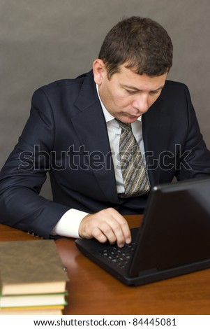 Pensive face businessman sitting at computer