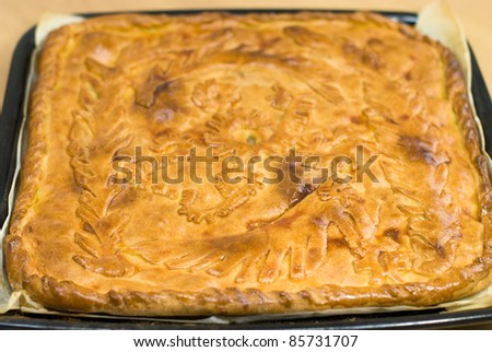 traditional Russian pie with meat and potatoes baked in the oven