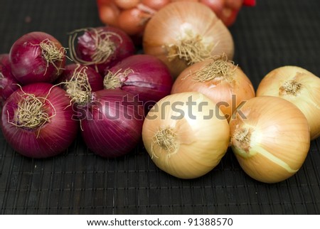 red and yellow bulb onions on black