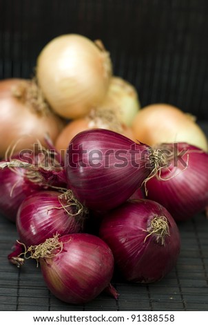 red and yellow bulb onions on black