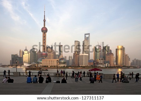 SHANGHAI, CHINA - APR 6: People are admiring the view of the Pudong skyline from the western bank of the Huangpu River on April 6, 2012 in Shanghai