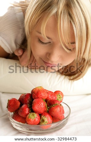 Young blonde woman with strawberries