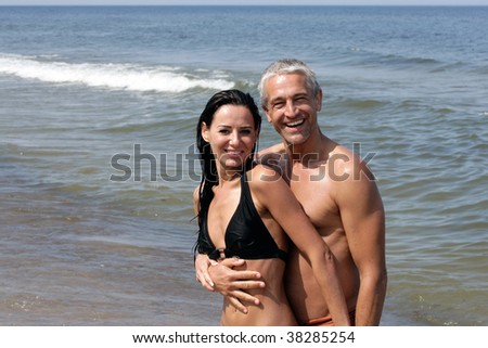 stock photo Attractive mature couple relaxing on the beach