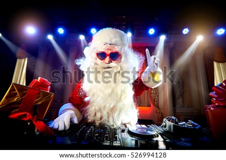 Dj  Santa Claus mixing at the party at Christmas