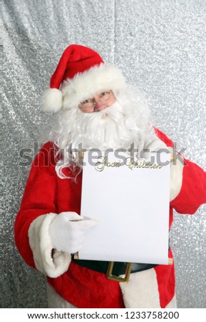 Santa Claus. Santa Claus with his Naughty or Nice List of Good or Bad Children. Santa Holds his list. text is removable and replaceable with your own. room for text.